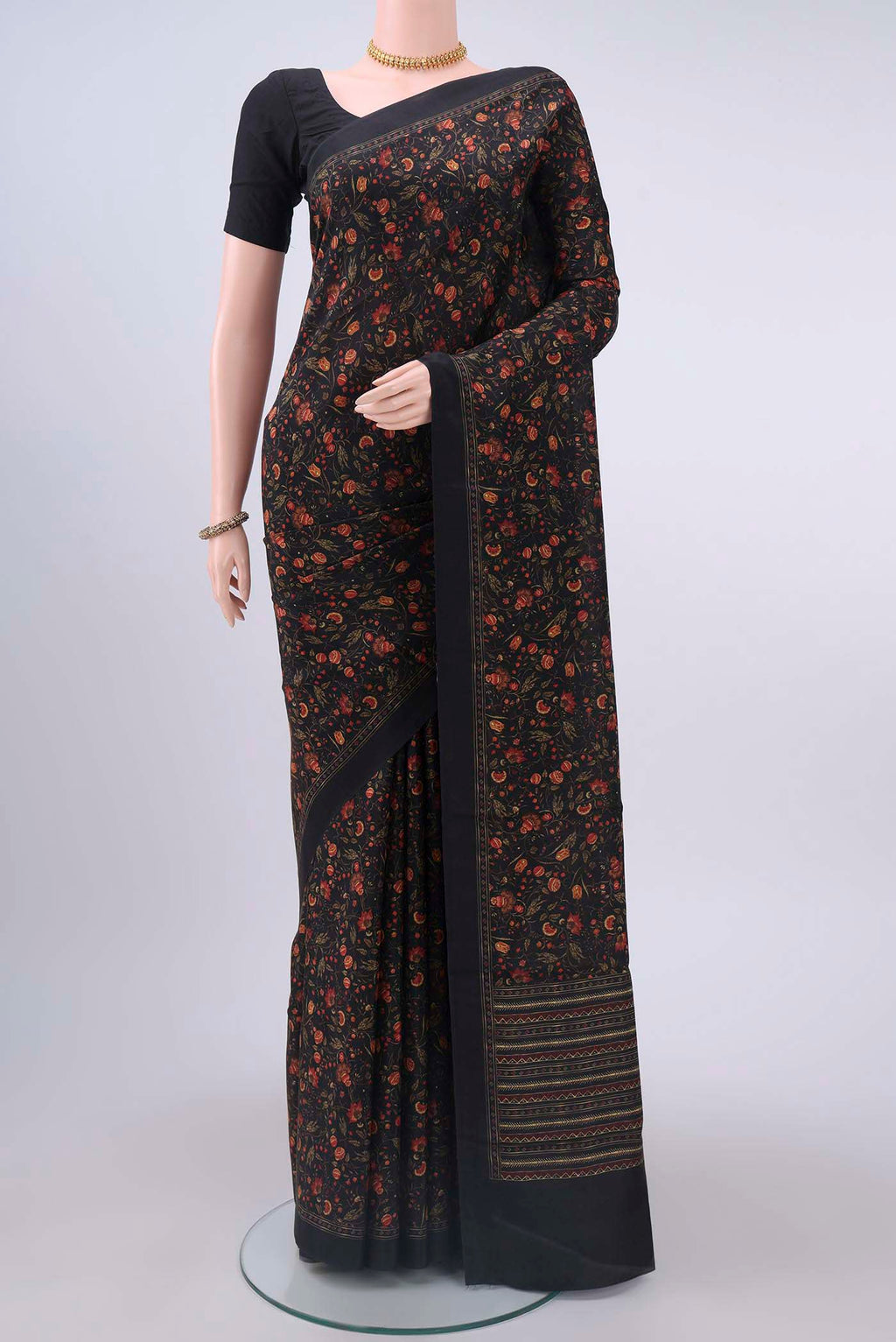 Black Printed Silk Saree with Printed design on the body and Lace Border displayed on a mannequin