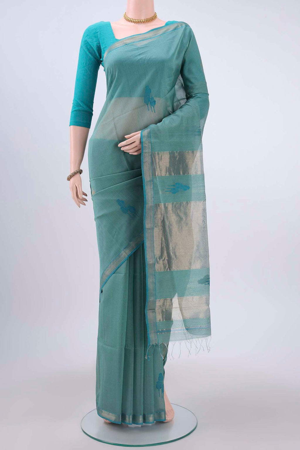Blue Maheshwari Silk Cotton Saree with Thread Butta on the body and Zari Border displayed on a mannequin