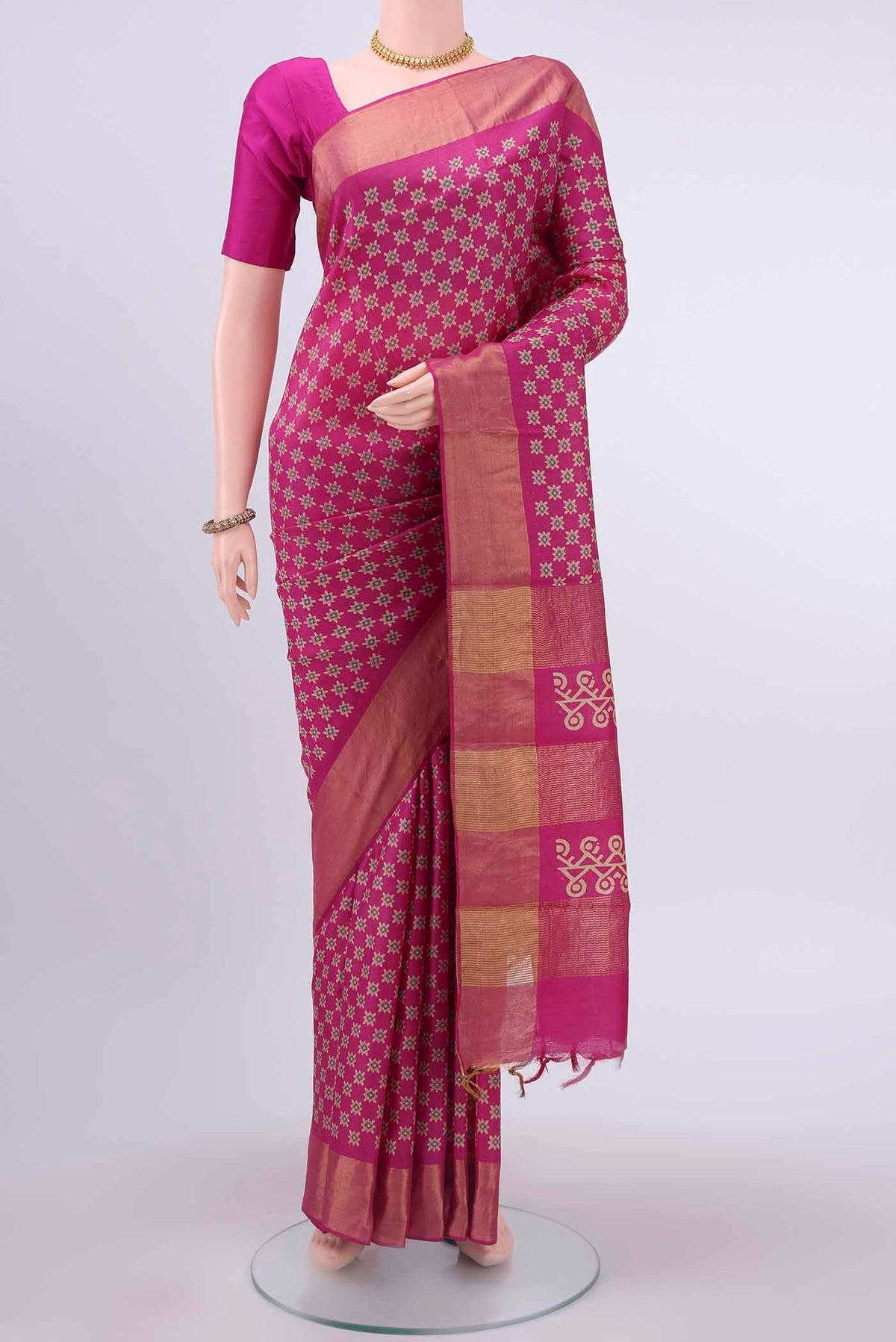 Rani Pink Dual Tone Tussar Silk Saree with Printed design on the body and Zari Border displayed on a mannequin