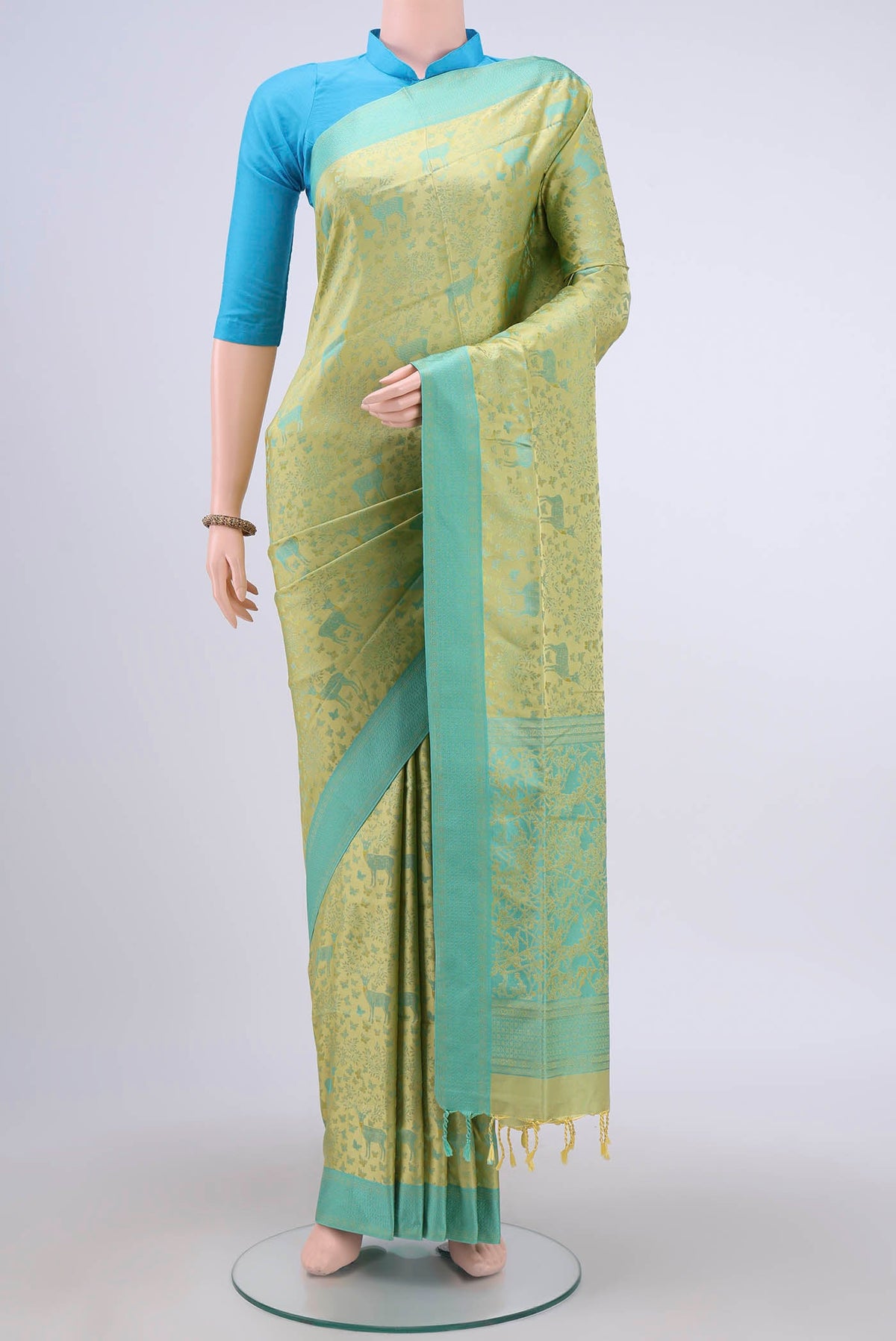 Pista Green Soft Silk Saree with Jacquard design on the body and Thread Border displayed on a mannequin