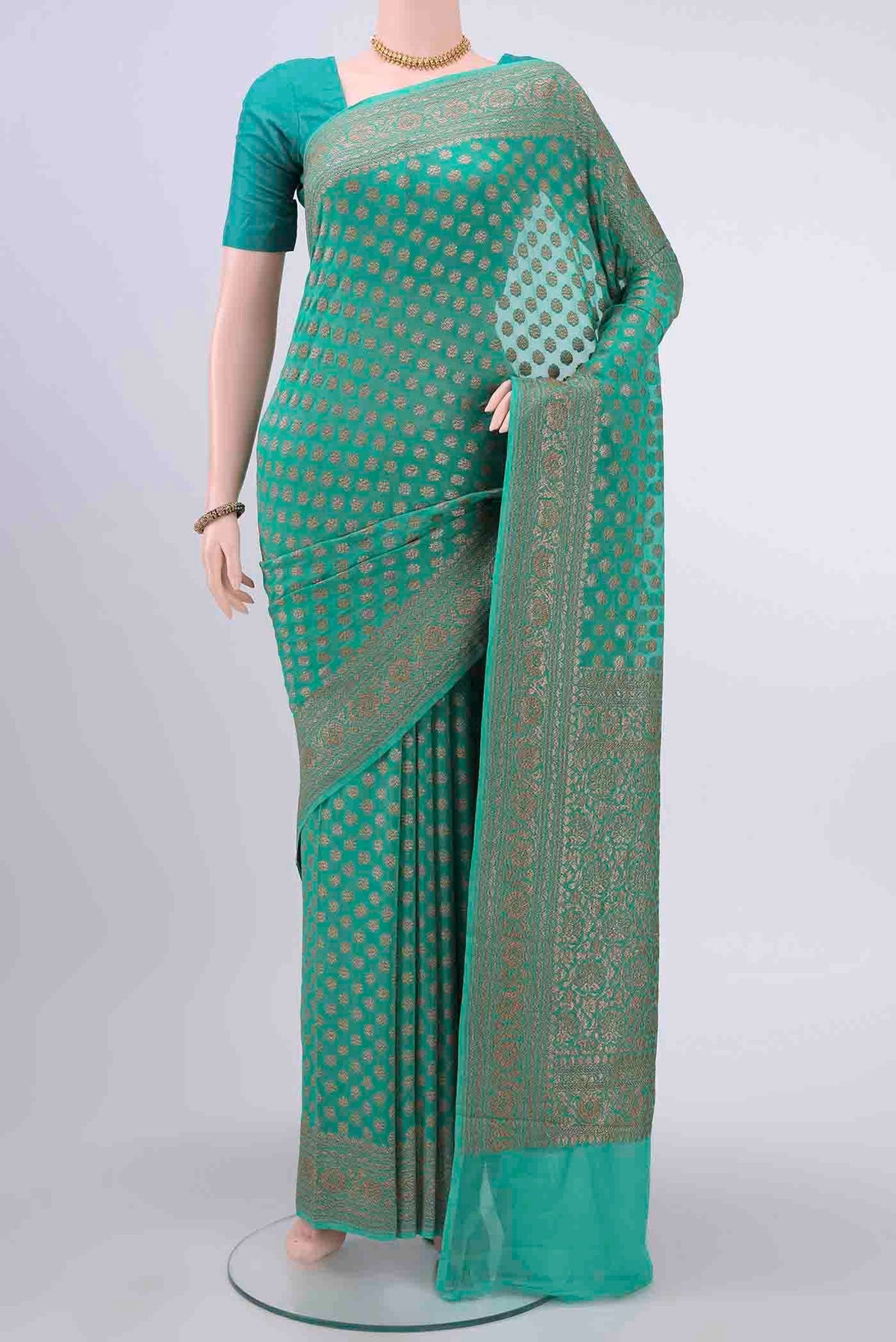 Sea Green Banarasi Georgette Saree with Zari Brocade on the body and Zari Border displayed on a mannequin