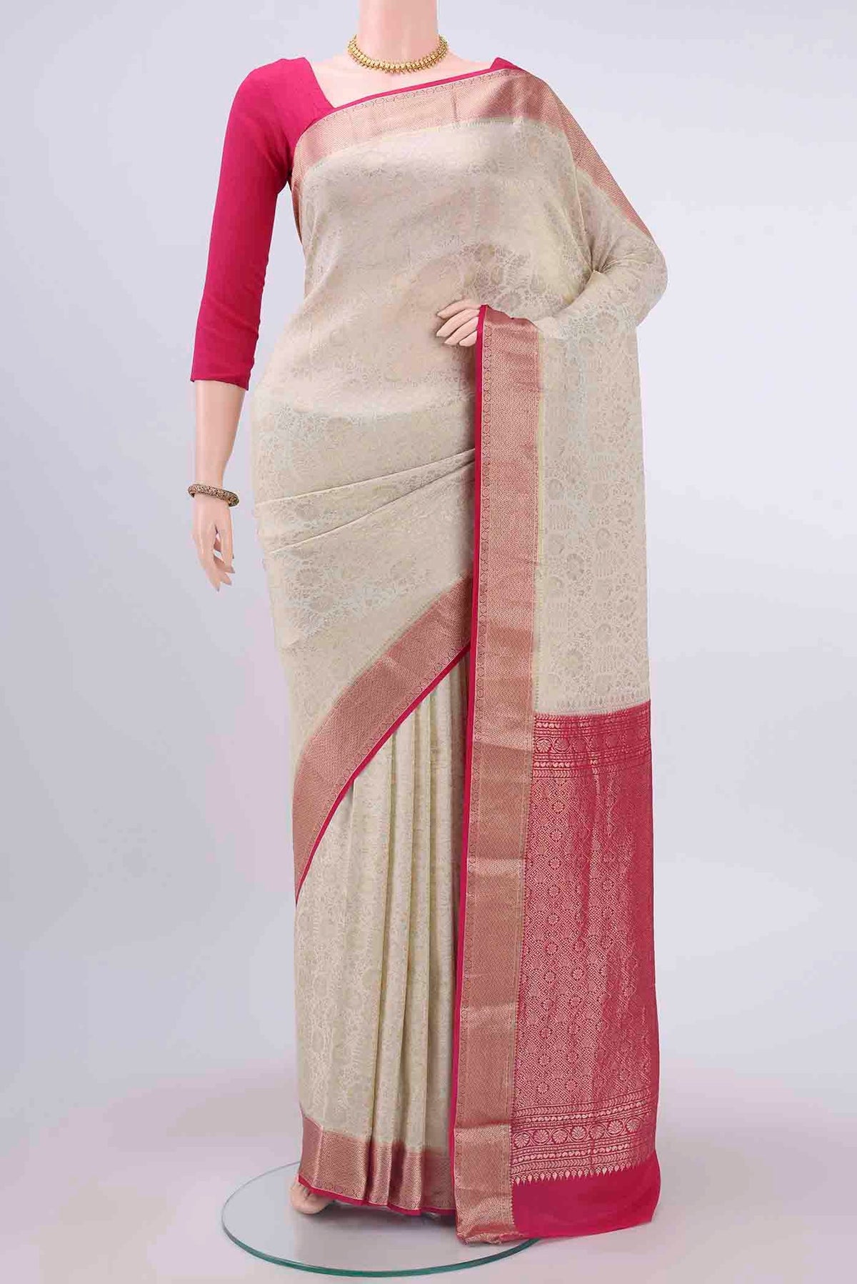 Off White Mysore Crepe Saree with Zari Brocade on the body and Zari Border displayed on a mannequin