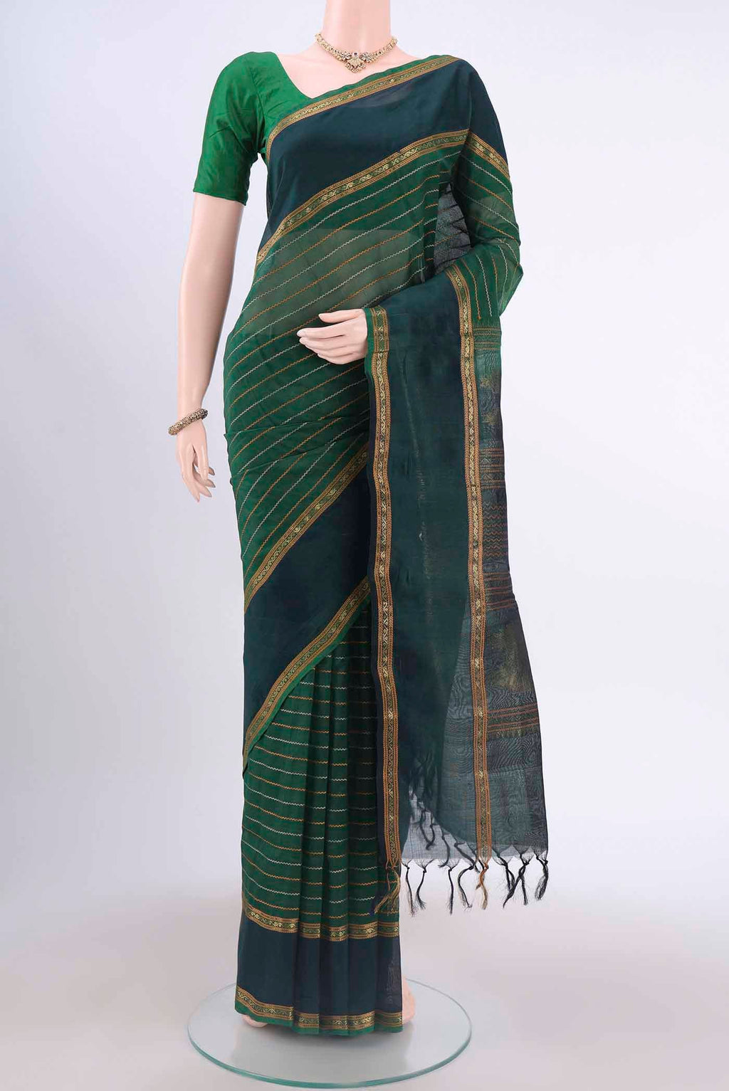 Green Silk Cotton Saree with Veldhari on the body and Zari Border displayed on a mannequin