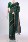 Green Silk Cotton Saree with Veldhari on the body and Zari Border displayed on a mannequin