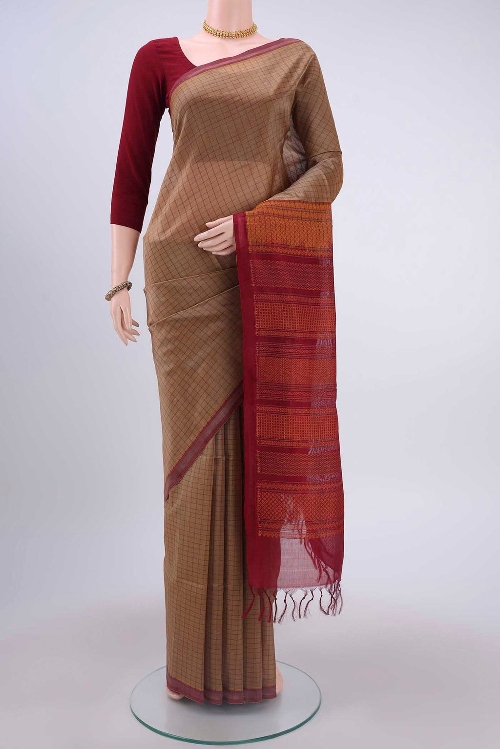 Beige Coimbatore Silk Cotton Saree with Checked design on the body and Plain Border displayed on a mannequin