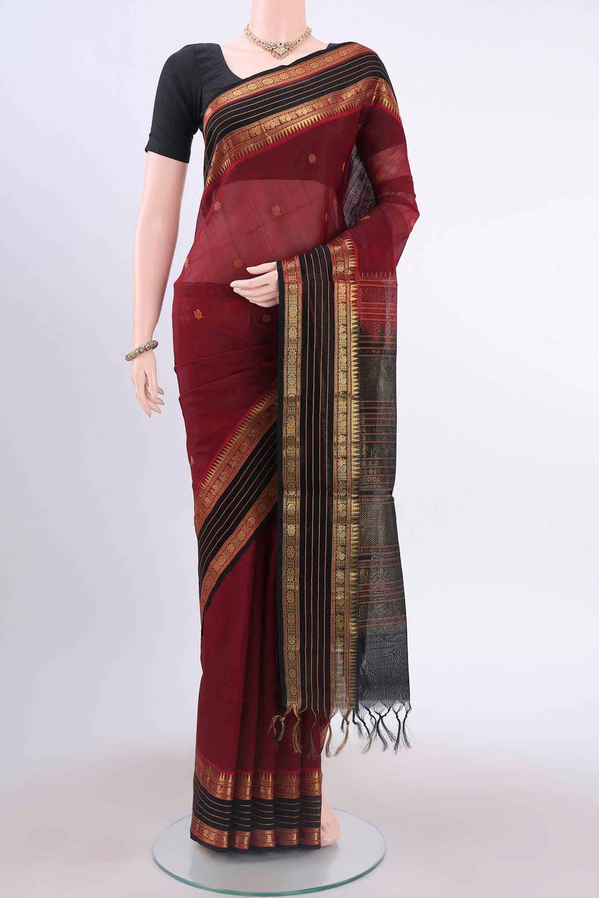 Maroon Silk Cotton Saree with Zari Butta on the body and Zari Border displayed on a mannequin