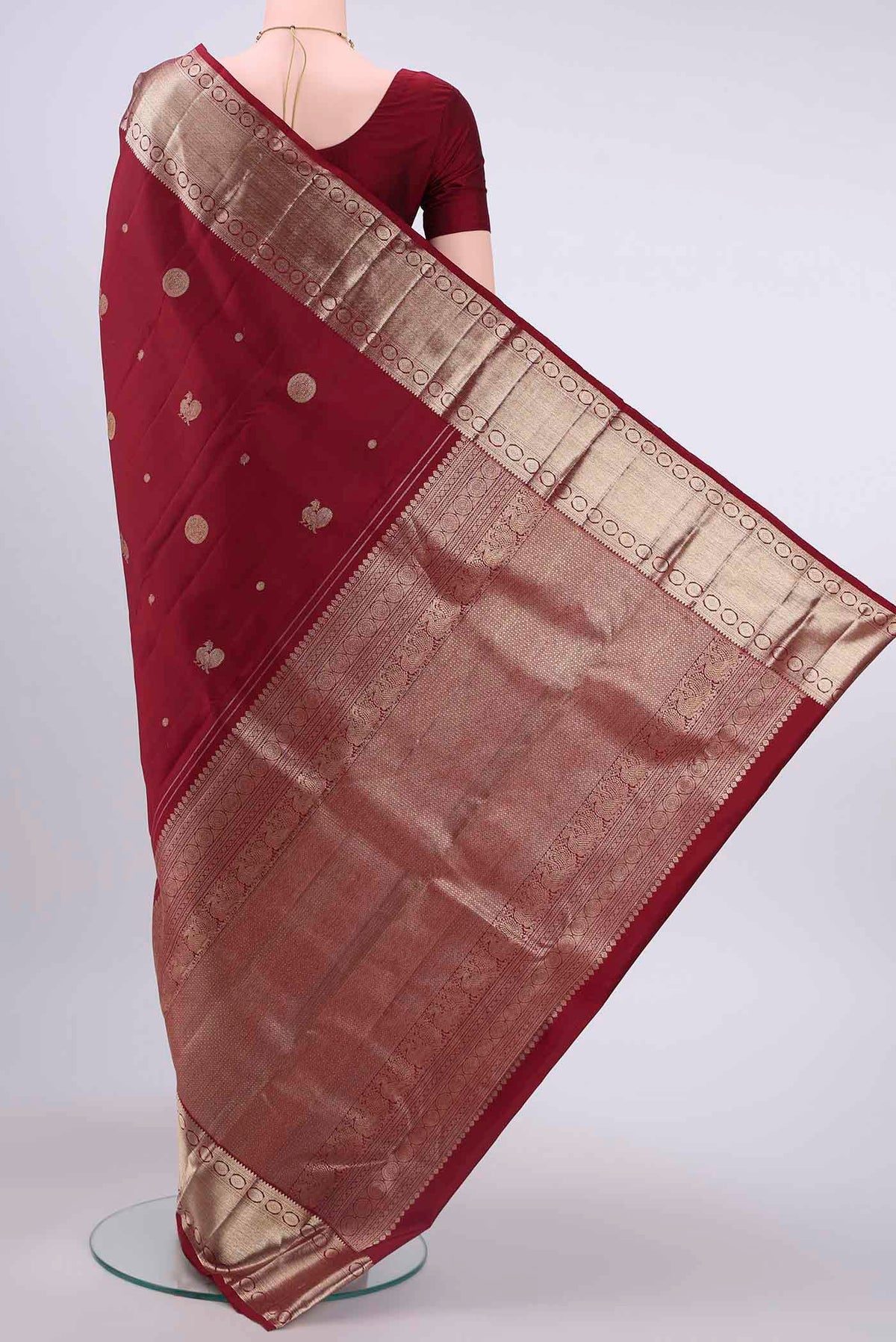 Flat view of Maroon Kanchipuram Saree with Zari Butta on the body and Zari Border