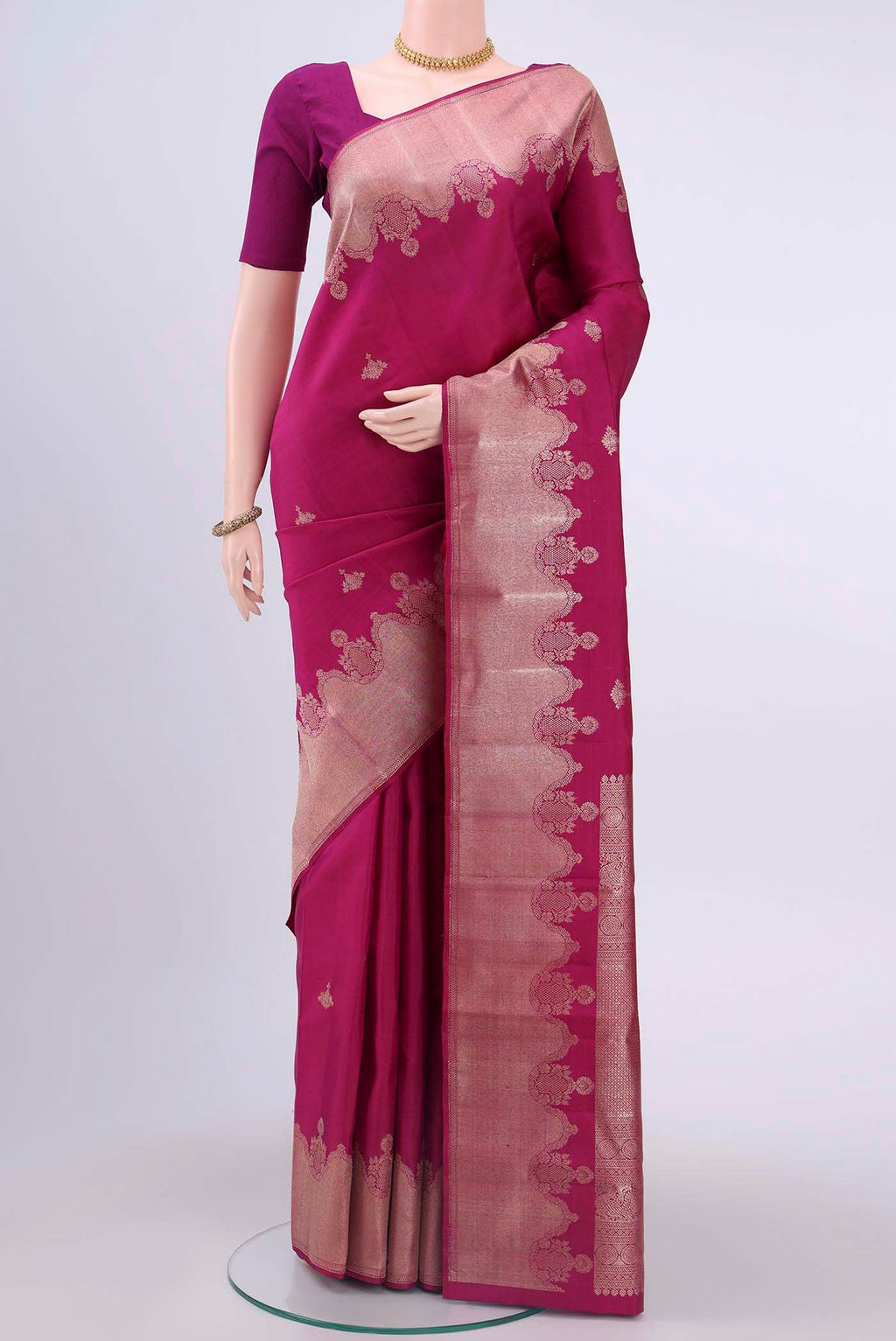 Dark Pink Kanchipuram Saree with Zari Butta on the body and Zari Border displayed on a mannequin