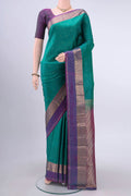 Green Kanchipuram Silk Saree with Zari Butta on the body and Zari Border displayed on a mannequin