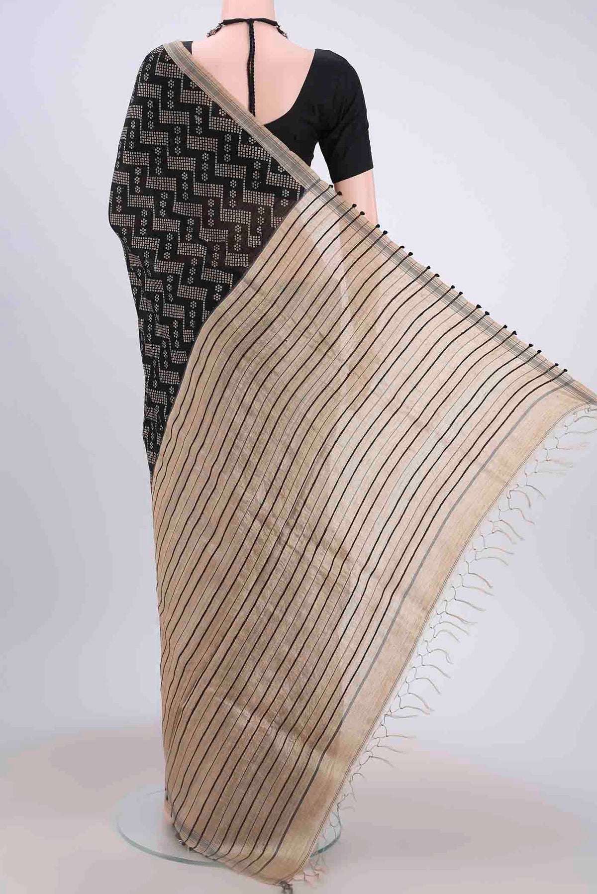Flat view of Black Tussar Silk Saree with Zig Zag design on the body and Plain Border