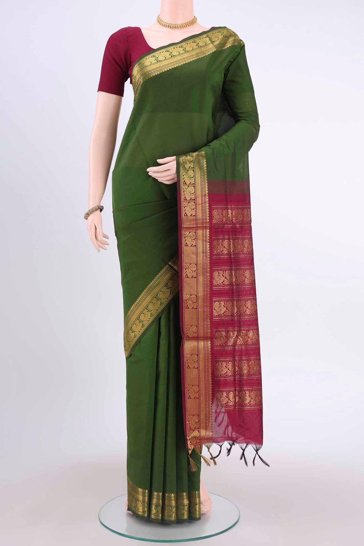 Green Blended Poly Cotton Saree with Plain Body and Zari Border displayed on a mannequin