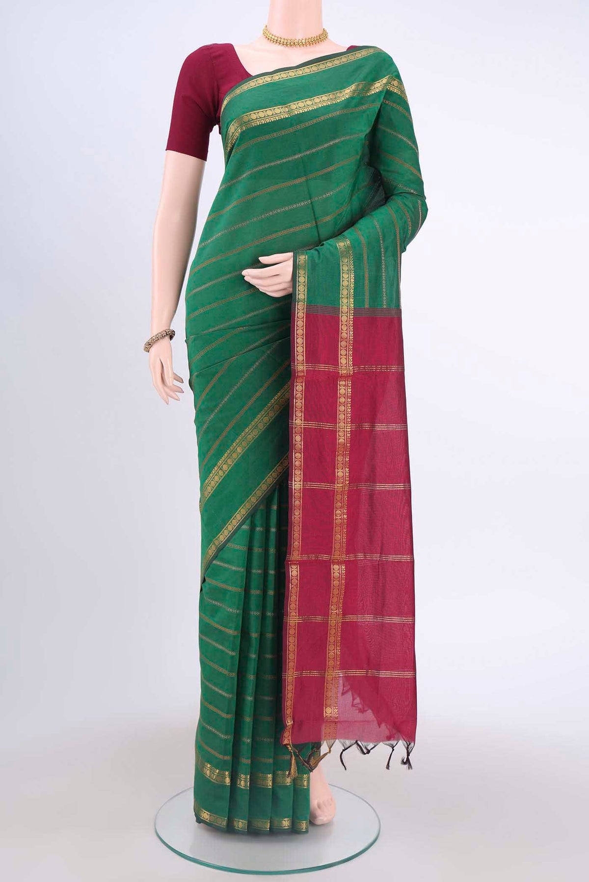 Green Blended Poly Cotton Saree with Stripes on the body and Zari Border displayed on a mannequin