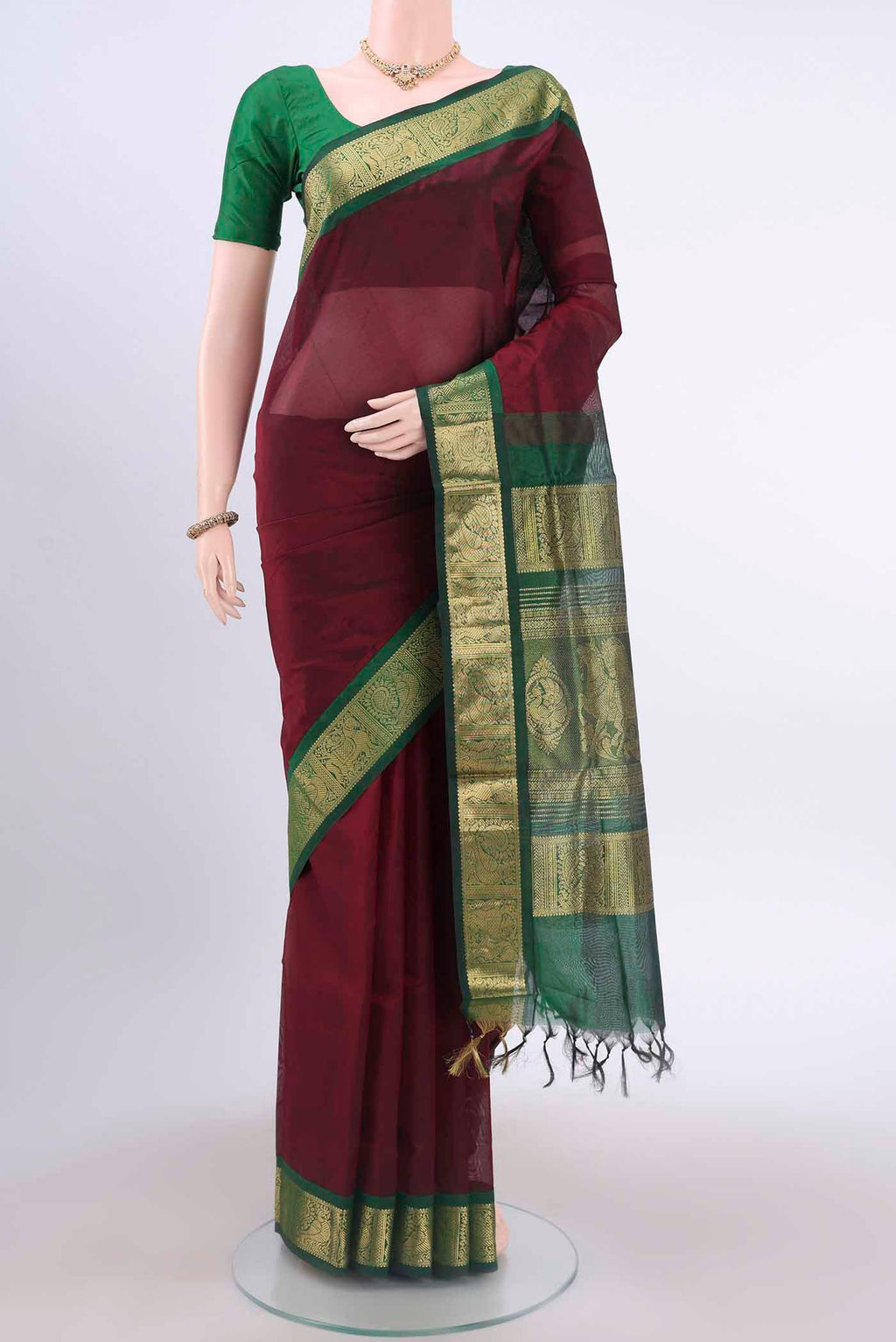 Maroon Silk Cotton Saree with Plain Body and Zari Border displayed on a mannequin