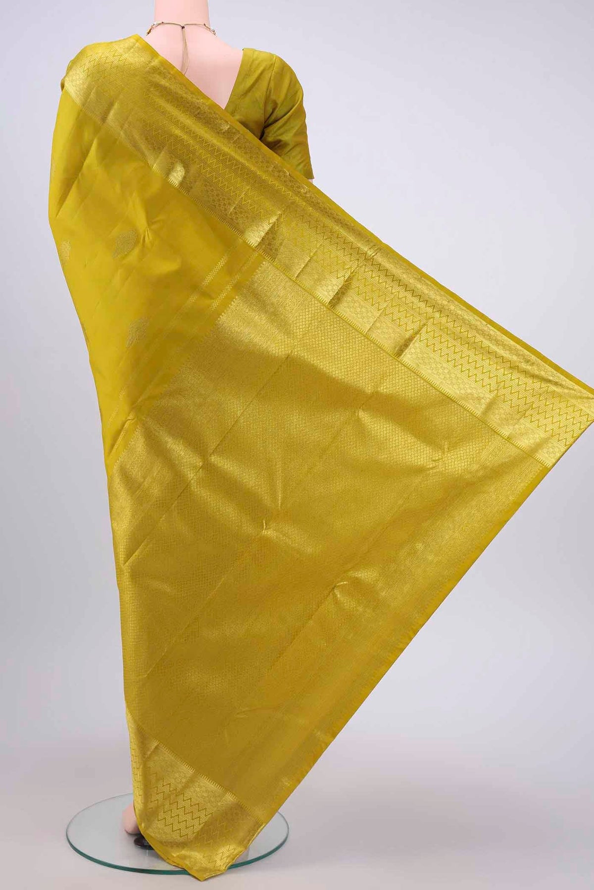 Flat view of Acid Green Kanchipuram Saree with Zari Butta on the body and Zari Border