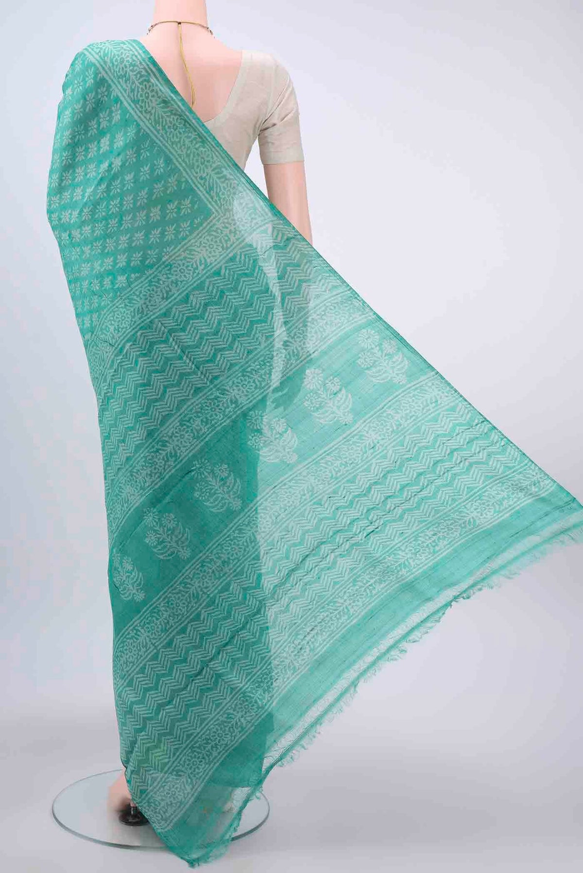 Flat view of Turquoise Tussar Silk Saree with Printed design on the body and Printed Border