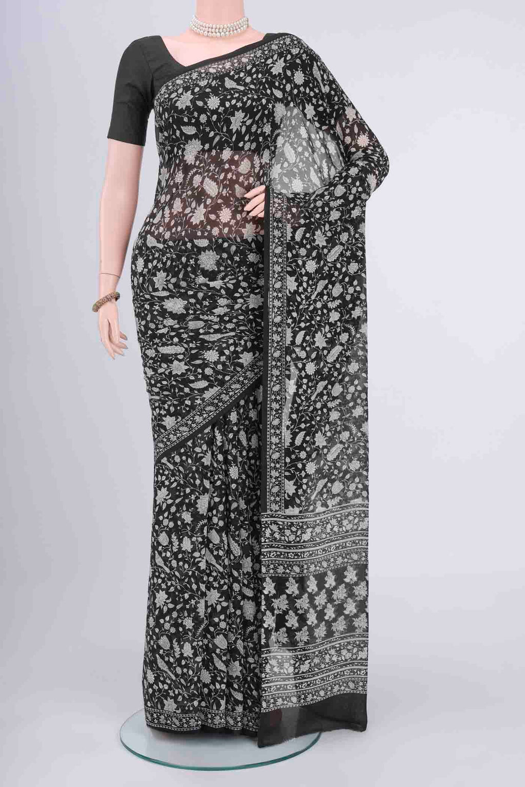 Black Mysore Crepe Saree with Floral Print on the body and Zari Border displayed on a mannequin