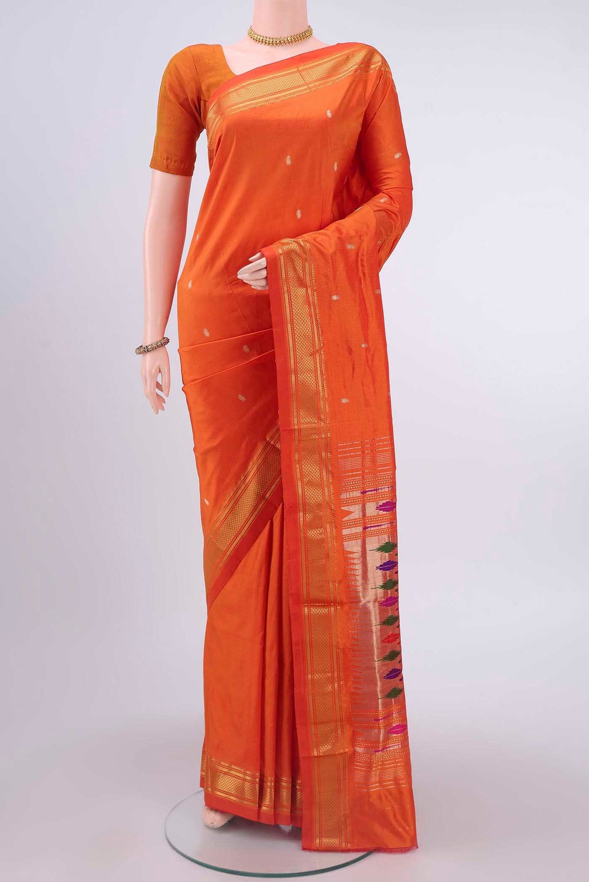 Brick Orange Paithani Silk Saree with Zari Butta on the body and Zari Border displayed on a mannequin