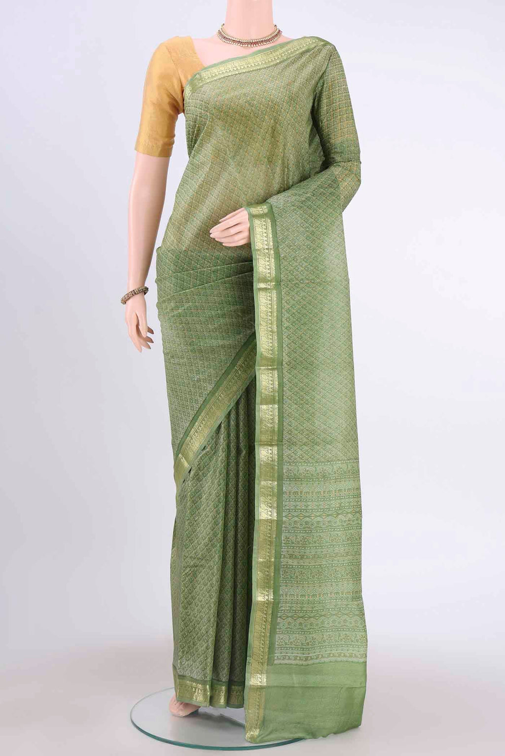 Light Green Printed Silk Saree with Floral Print on the body and Zari Border displayed on a mannequin