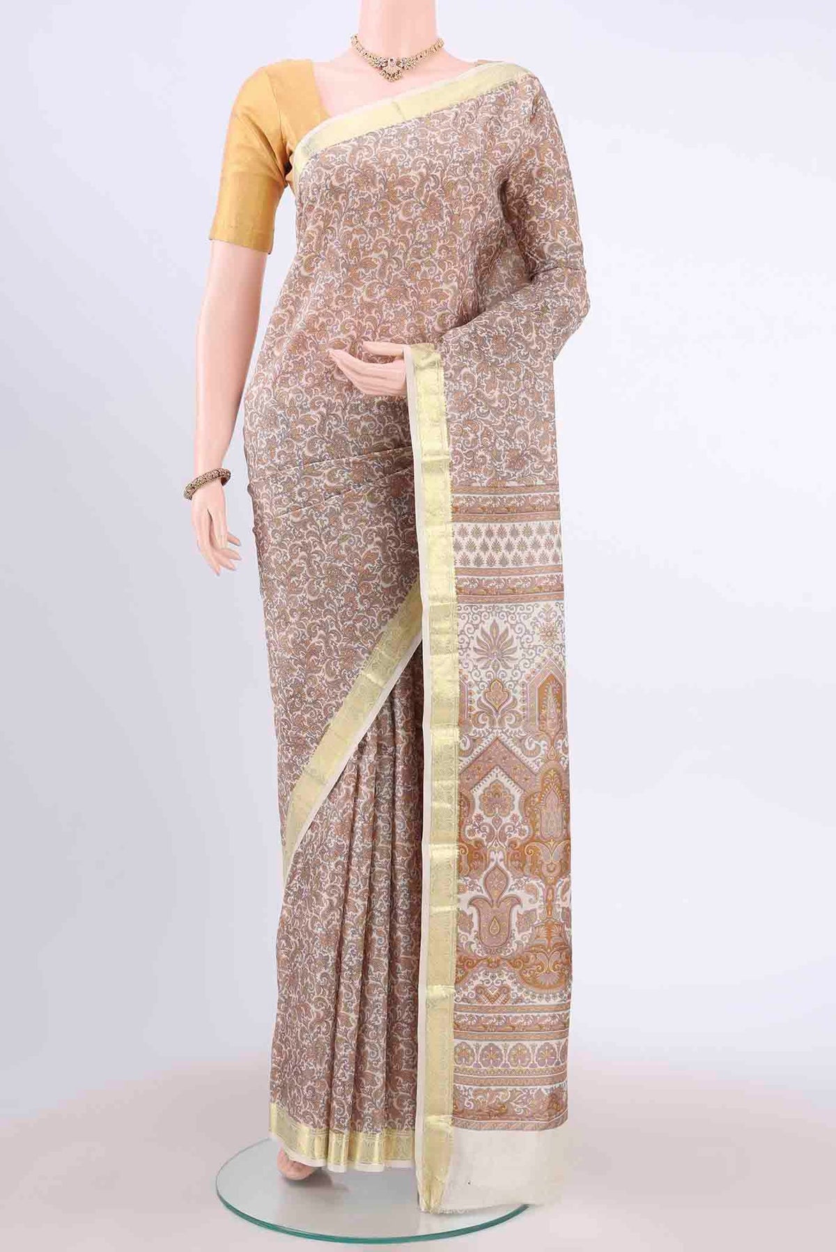 Off White Printed Silk Saree with Floral Print on the body and Zari Border displayed on a mannequin