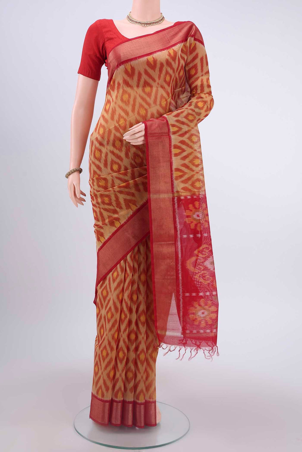 Beige Kora Cotton Saree with Ikat design on the body and Zari Border displayed on a mannequin