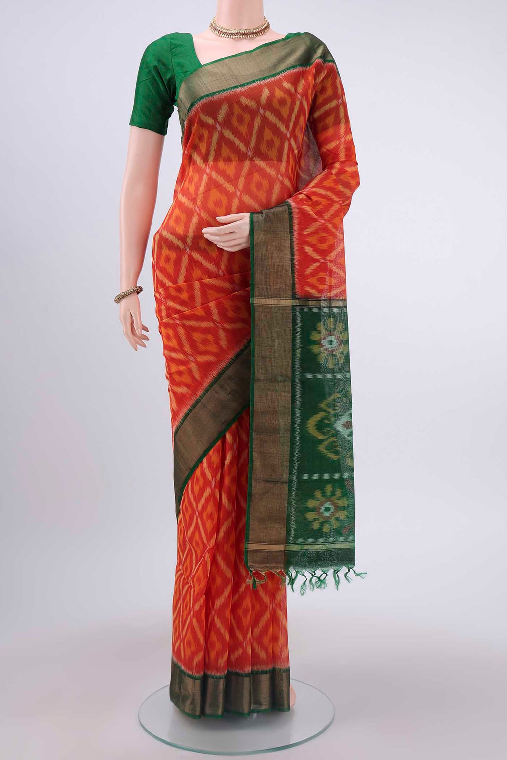 Brick Orange Kora Cotton Saree with Ikat design on the body and Zari Border displayed on a mannequin