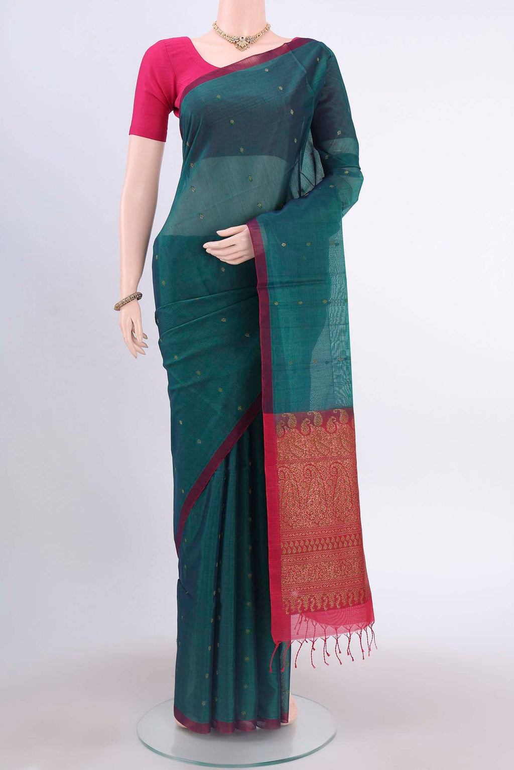 Bottle Green Kora Cotton Saree with Zari Butta on the body and Zari Border displayed on a mannequin