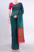 Bottle Green Kora Cotton Saree with Zari Butta on the body and Zari Border displayed on a mannequin