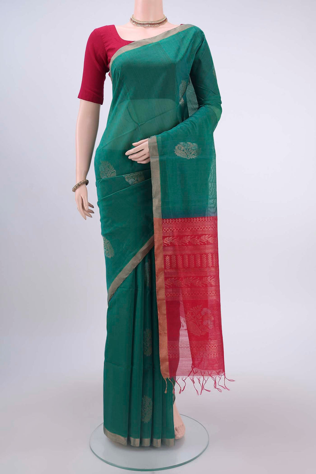 Sea Green Kora Cotton Saree with Zari Butta on the body and Zari Border displayed on a mannequin