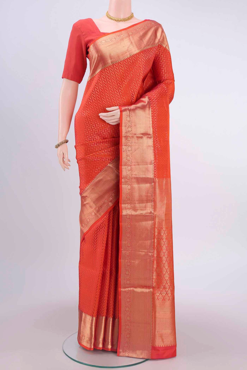 Brick Orange Soft Silk Saree with Jacquard With Zari Butta on the body and Zari Border displayed on a mannequin