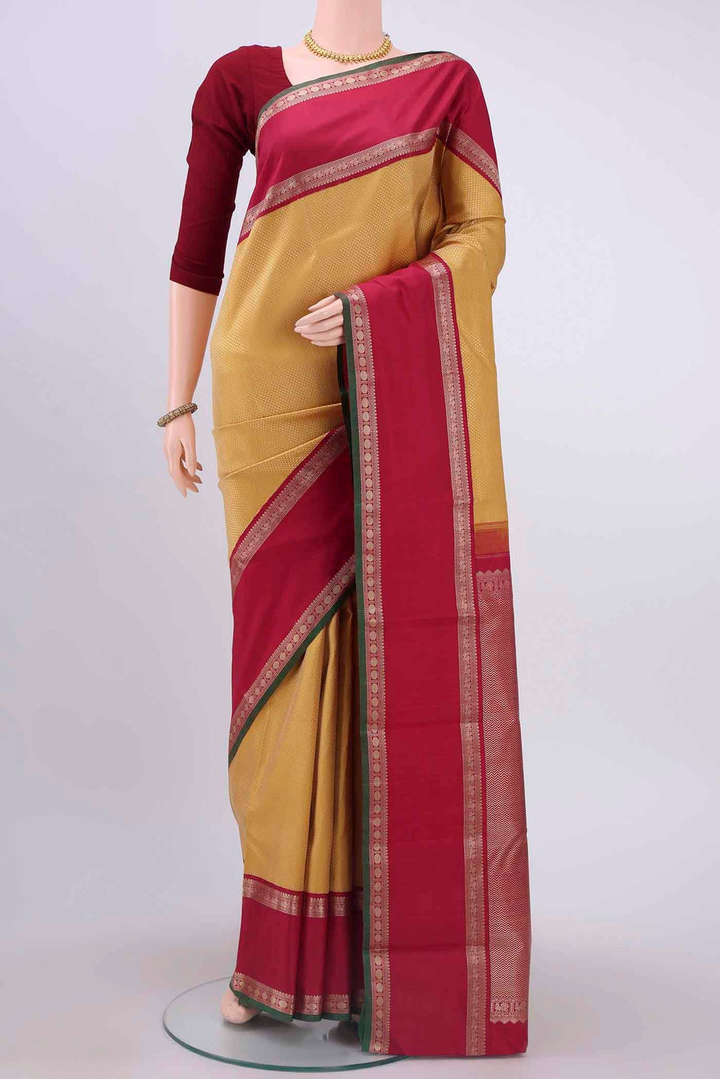 Yellow Kanchipuram Silk Saree with Jacquard design on the body and Thread Border displayed on a mannequin
