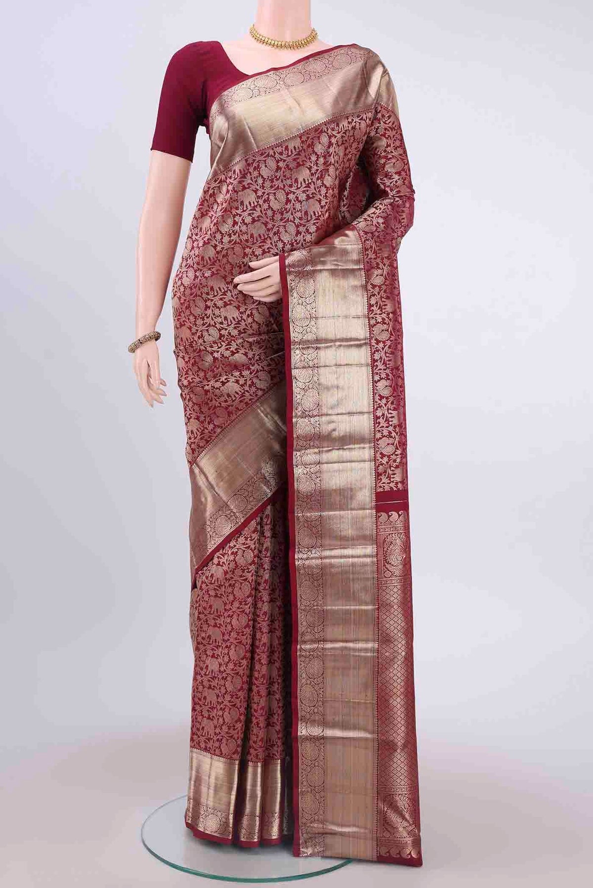 Maroon Kanchipuram Saree with Zari Brocade on the body and Zari Border displayed on a mannequin