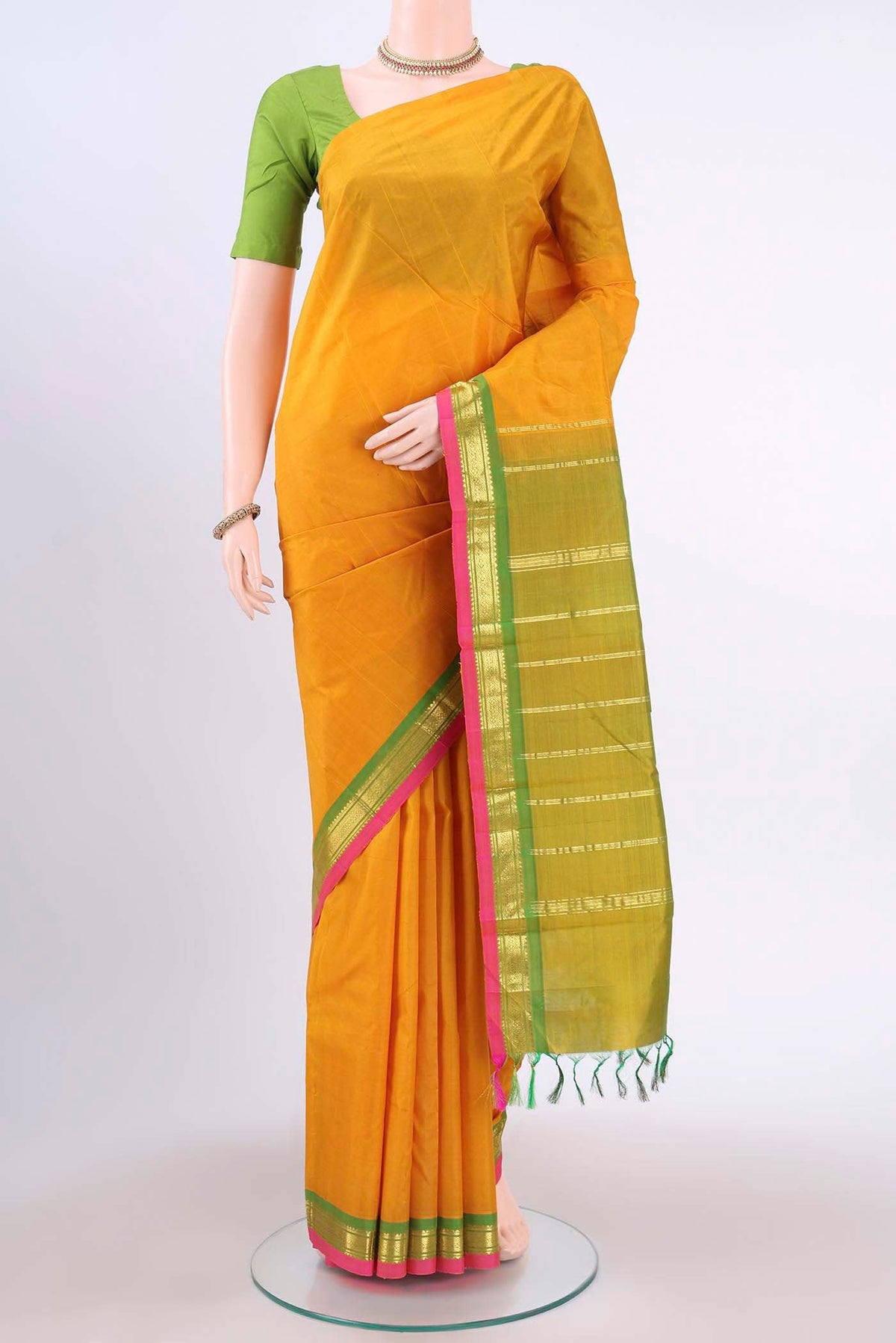 Mustard Kanchipuram Silk Saree with Zari Butta on the body and One Side Border displayed on a mannequin