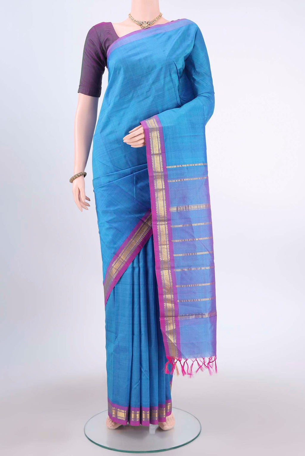 Turquoise Kanchipuram Silk Saree with Zari Butta on the body and One Side Border displayed on a mannequin