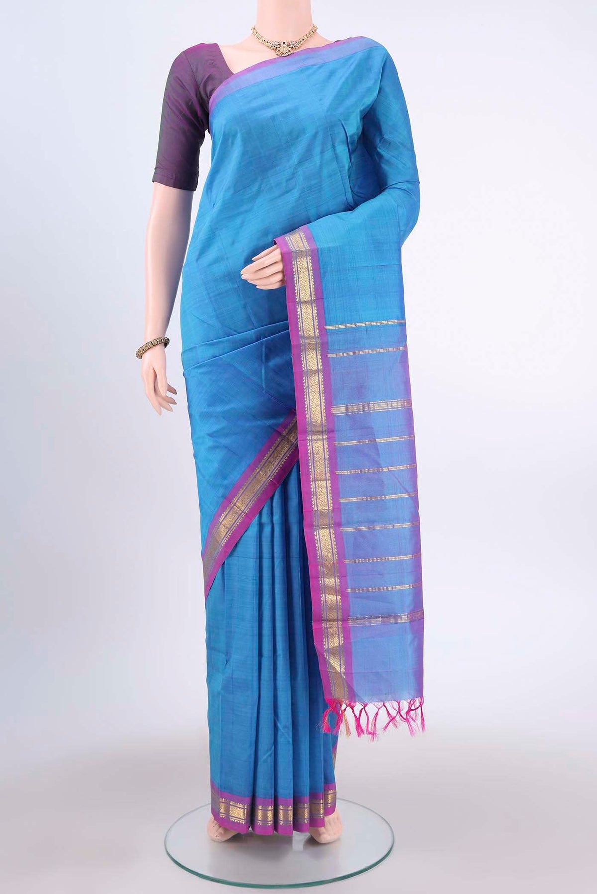 Turquoise Kanchipuram Silk Saree with Zari Butta on the body and One Side Border displayed on a mannequin