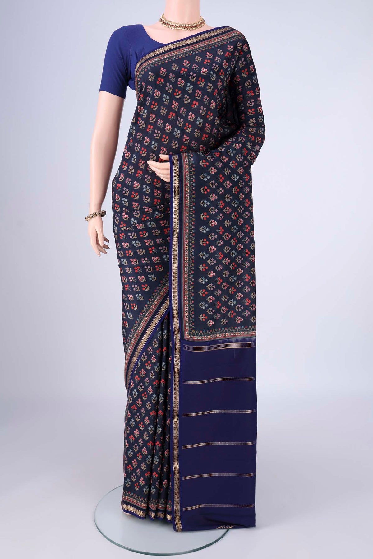 Navy Blue Printed Silk Saree with Printed design on the body and Zari Border.  displayed on a mannequin