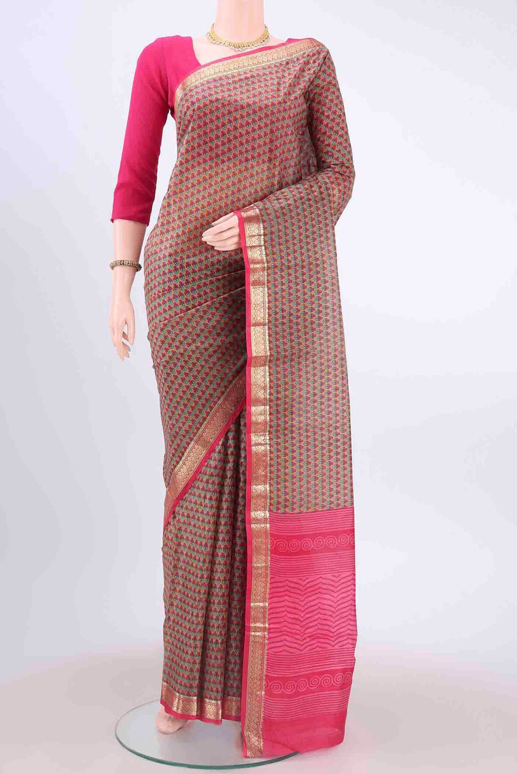 Pink Printed Silk Saree with Floral Print on the body and Zari Border displayed on a mannequin