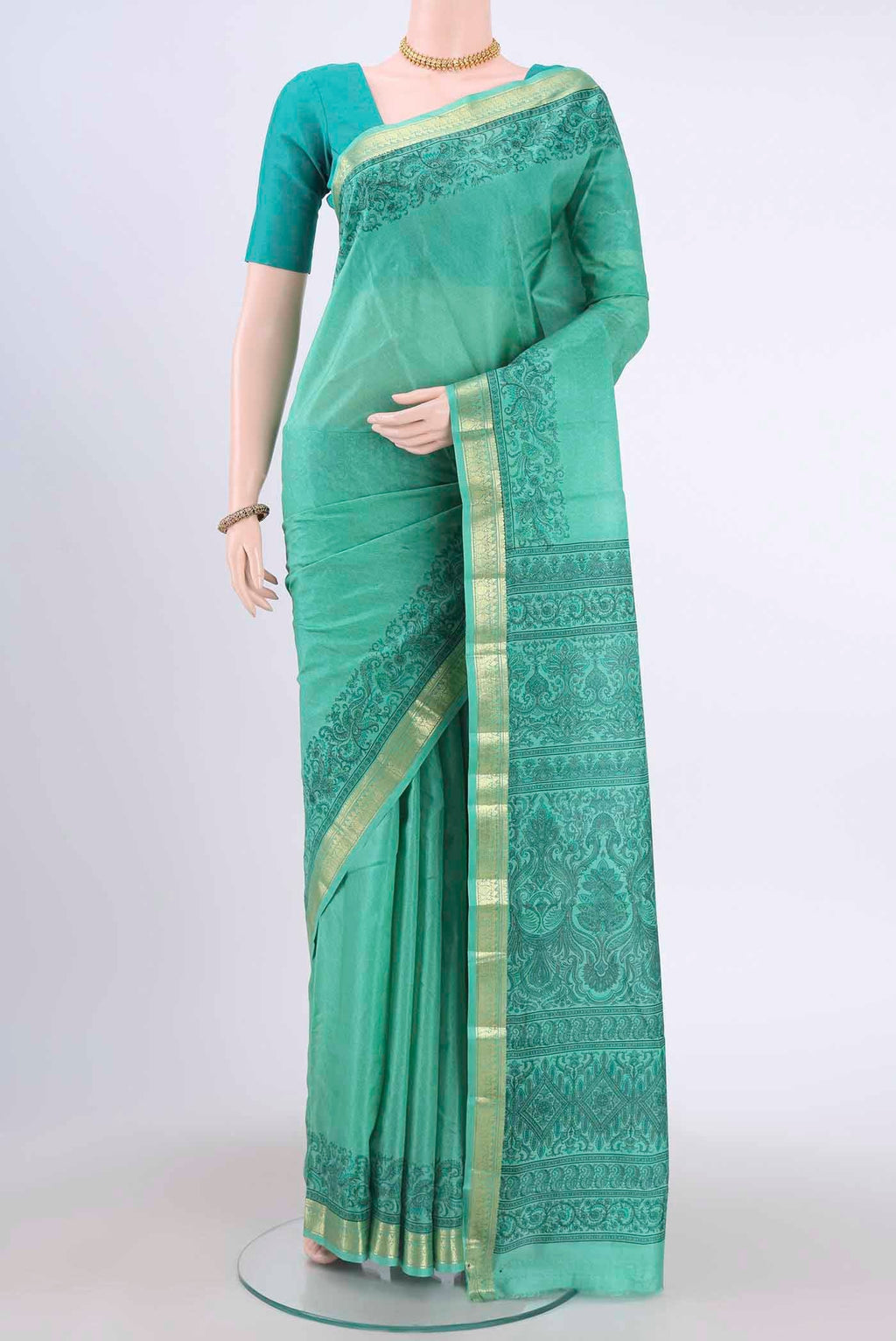 Light Green Printed Silk Saree with Floral Print on the body and Zari Border displayed on a mannequin