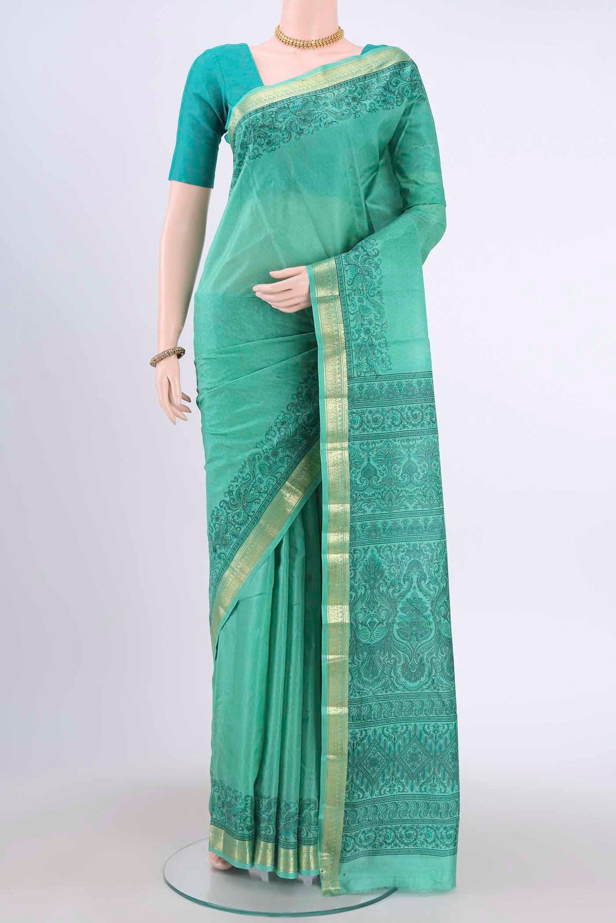 Light Green Printed Silk Saree with Floral Print on the body and Zari Border displayed on a mannequin