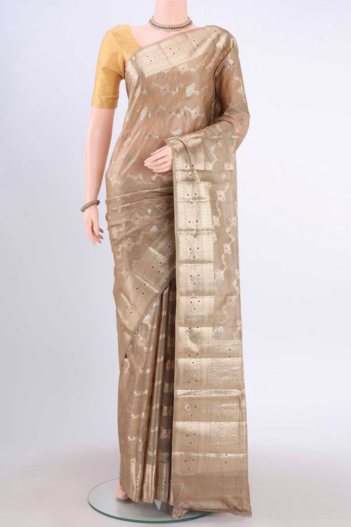 Beige Banarasi Tussar Silk Saree with Zari And Thread Butta on the body and Zari Border displayed on a mannequin