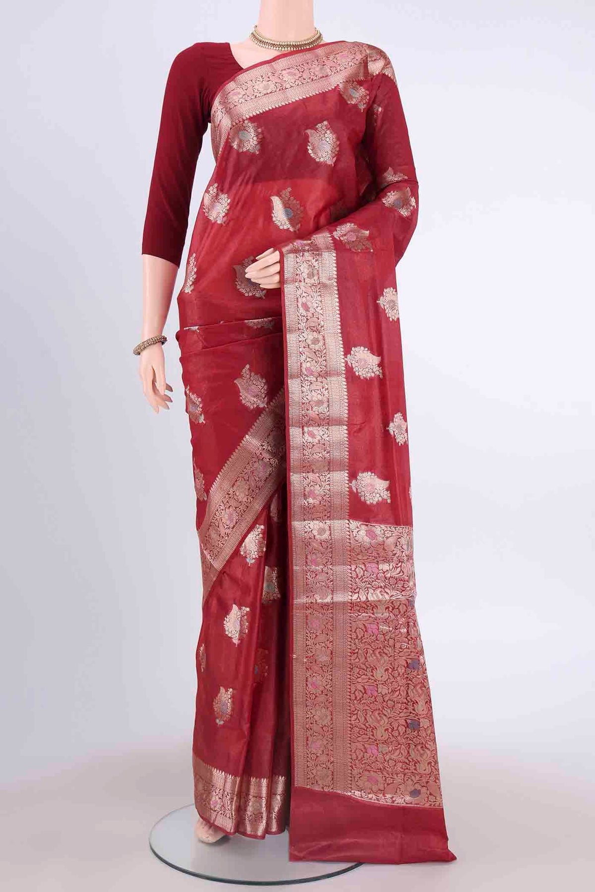 Maroon Banarasi Tussar Silk Saree with Zari And Thread Butta on the body and Zari And Thread Border displayed on a mannequin