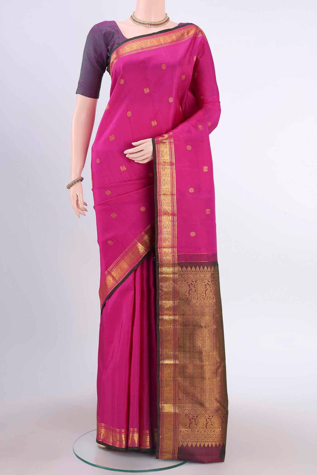 Dark Pink Kanchipuram Silk Saree with Zari Butta on the body and Zari Border displayed on a mannequin