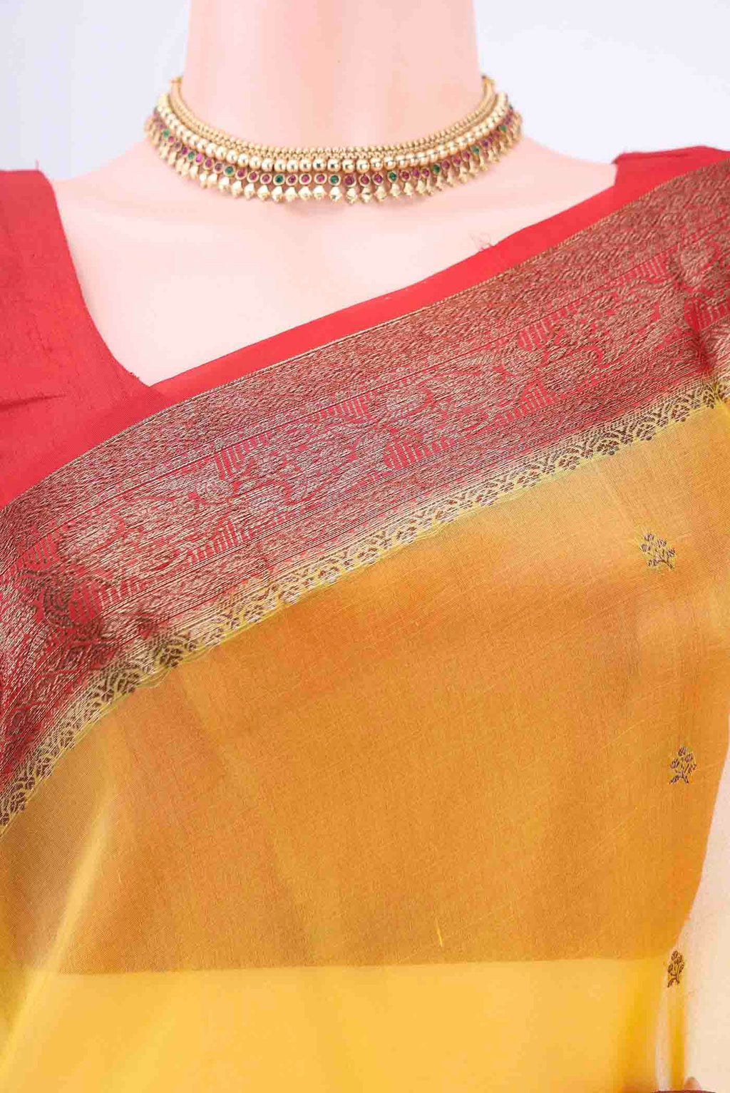 Border image of Yellow Organza Silk Saree with Zari Butta on the body and Zari Border