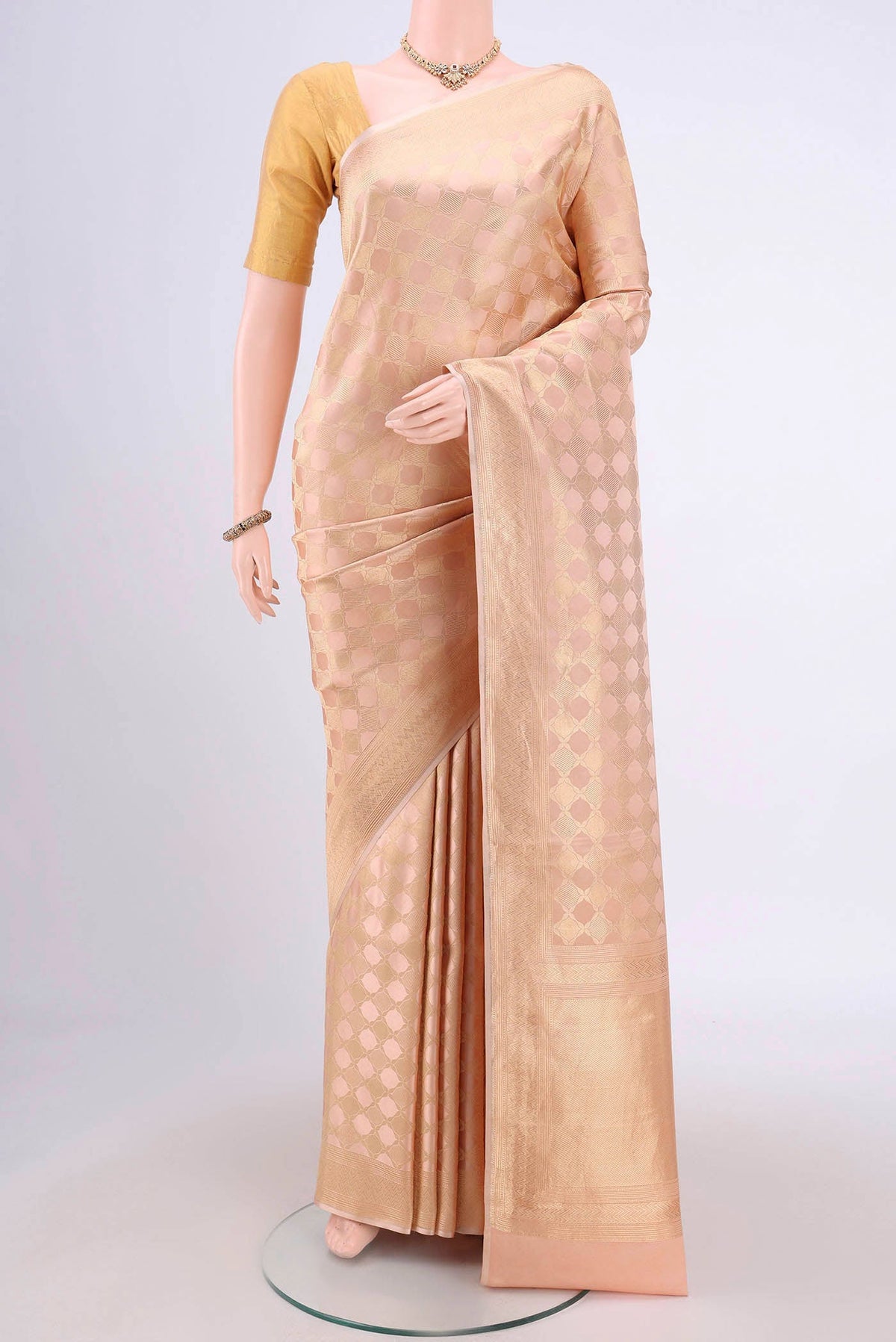 Rose Gold Banarasi Katan Silk Saree with Zari Brocade on the body and Zari Border.  displayed on a mannequin