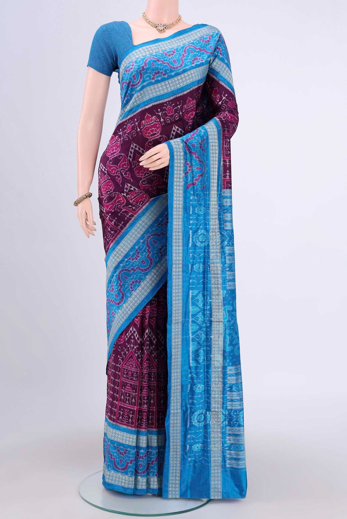Purple Orissa Silk Saree with Ikat design on the body and Thread Border.  displayed on a mannequin