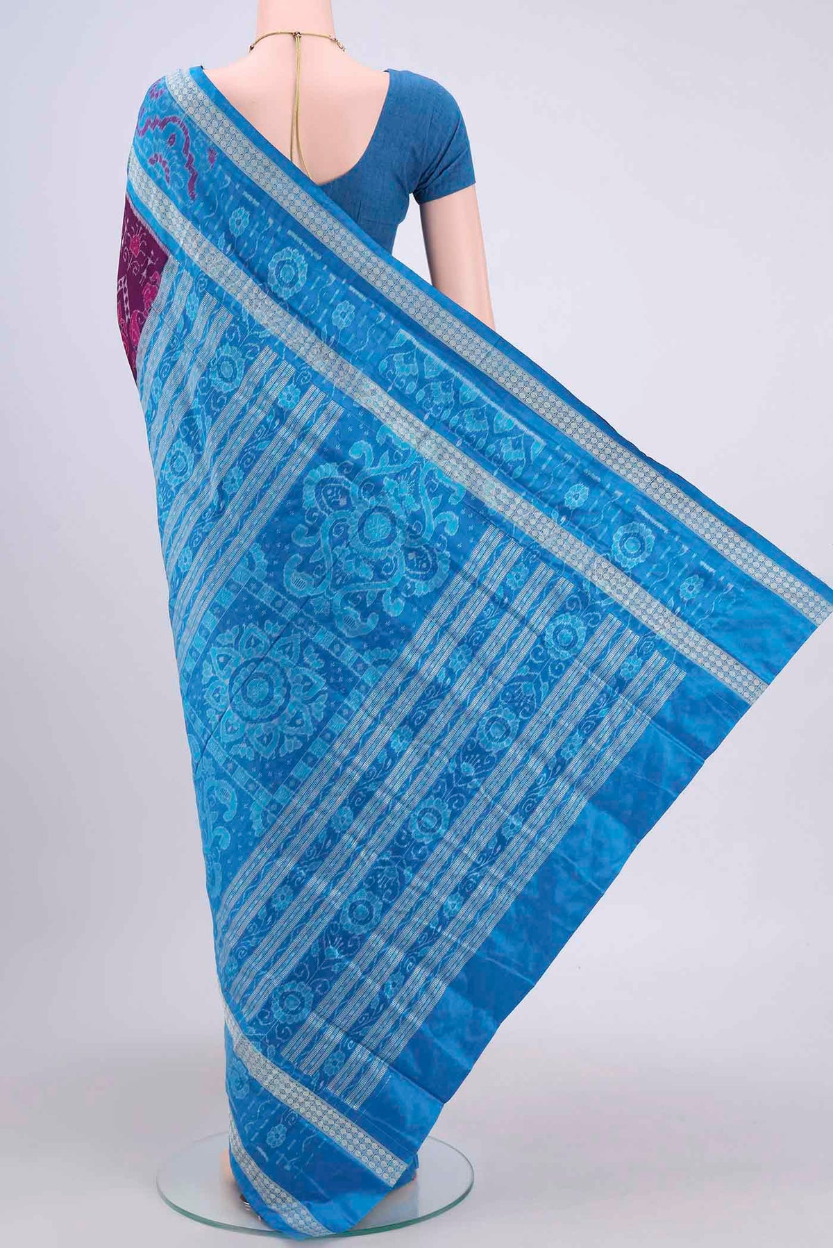 Flat view of Purple Orissa Silk Saree with Ikat design on the body and Thread Border. 