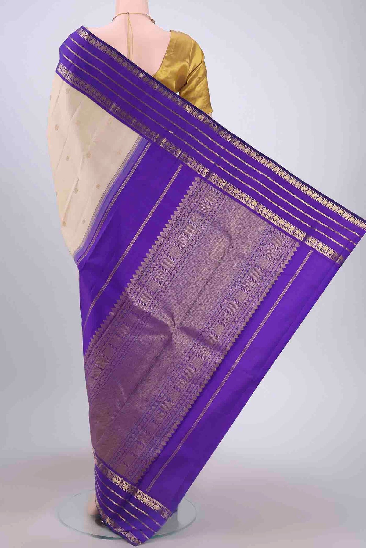Flat view of Pure Silk Pure Zari Off White Kanchipuram Saree with Zari Butta on the body and Zari Border