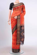 Brick Orange Kora Cotton Saree with Ikat Print on the body and Zari Border displayed on a mannequin