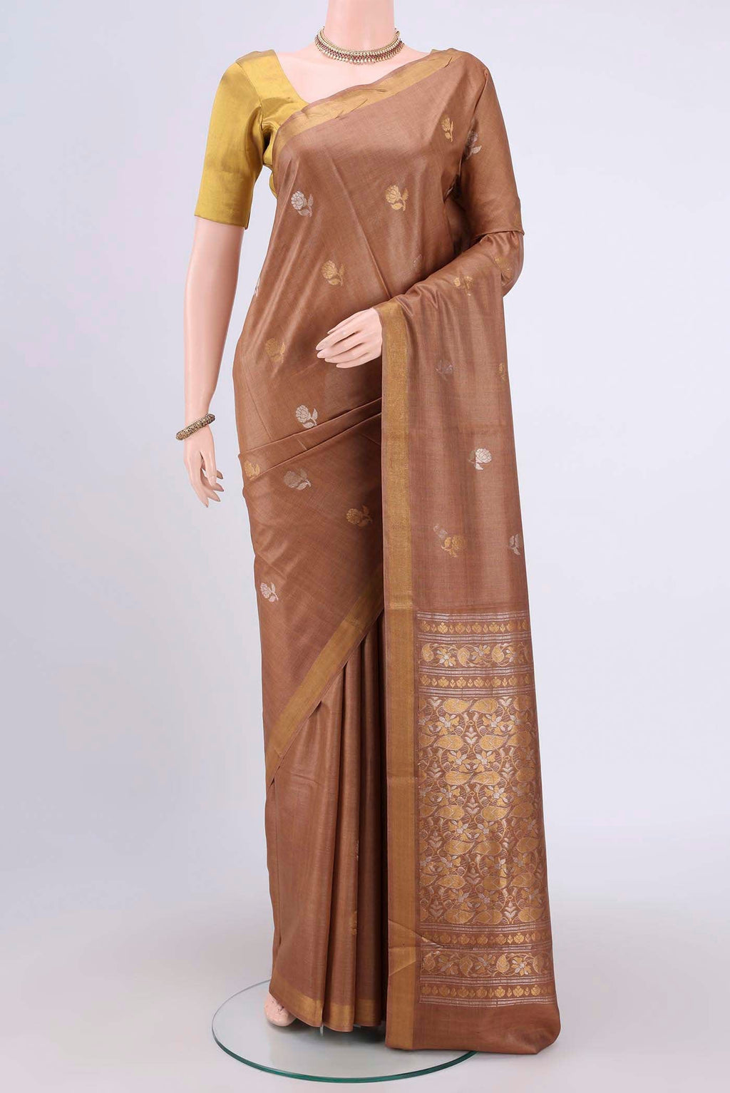 Brown Tussar Silk Saree with Zari Butta on the body and Zari Border.  displayed on a mannequin