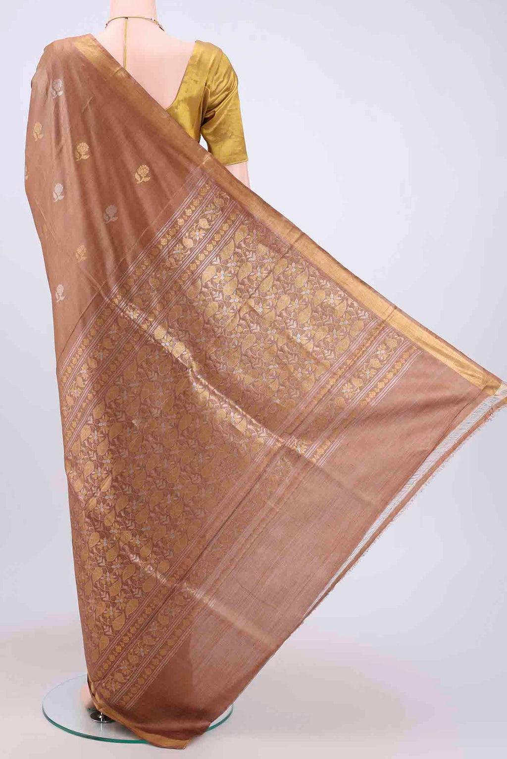 Flat view of Brown Tussar Silk Saree with Zari Butta on the body and Zari Border. 