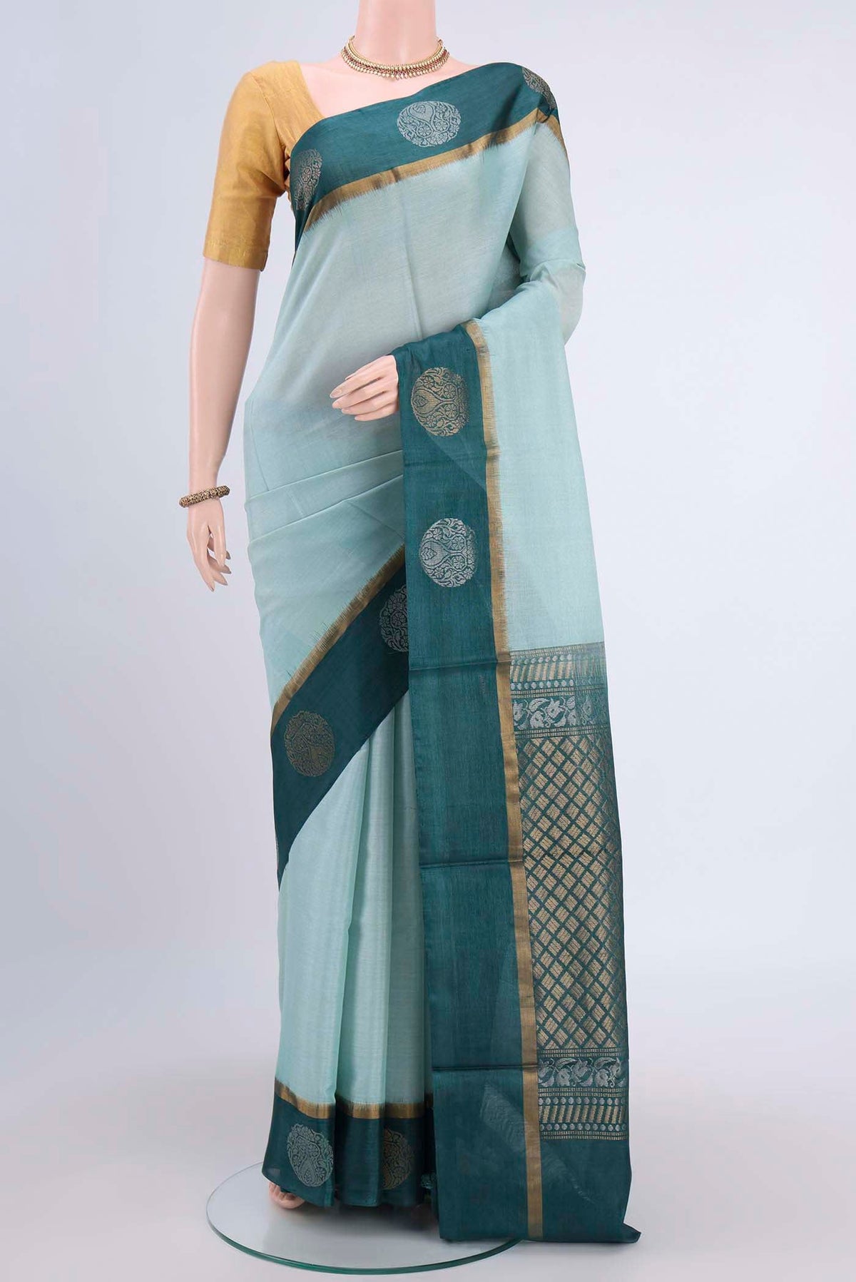 Light Blue Tussar Silk Saree with Plain Body and Zari Border displayed on a mannequin